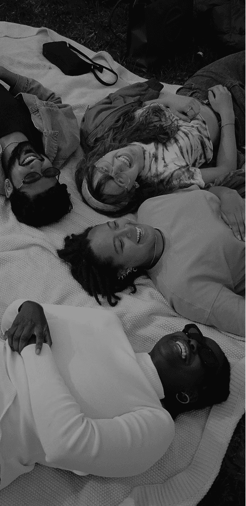 people laying next to each and smiling